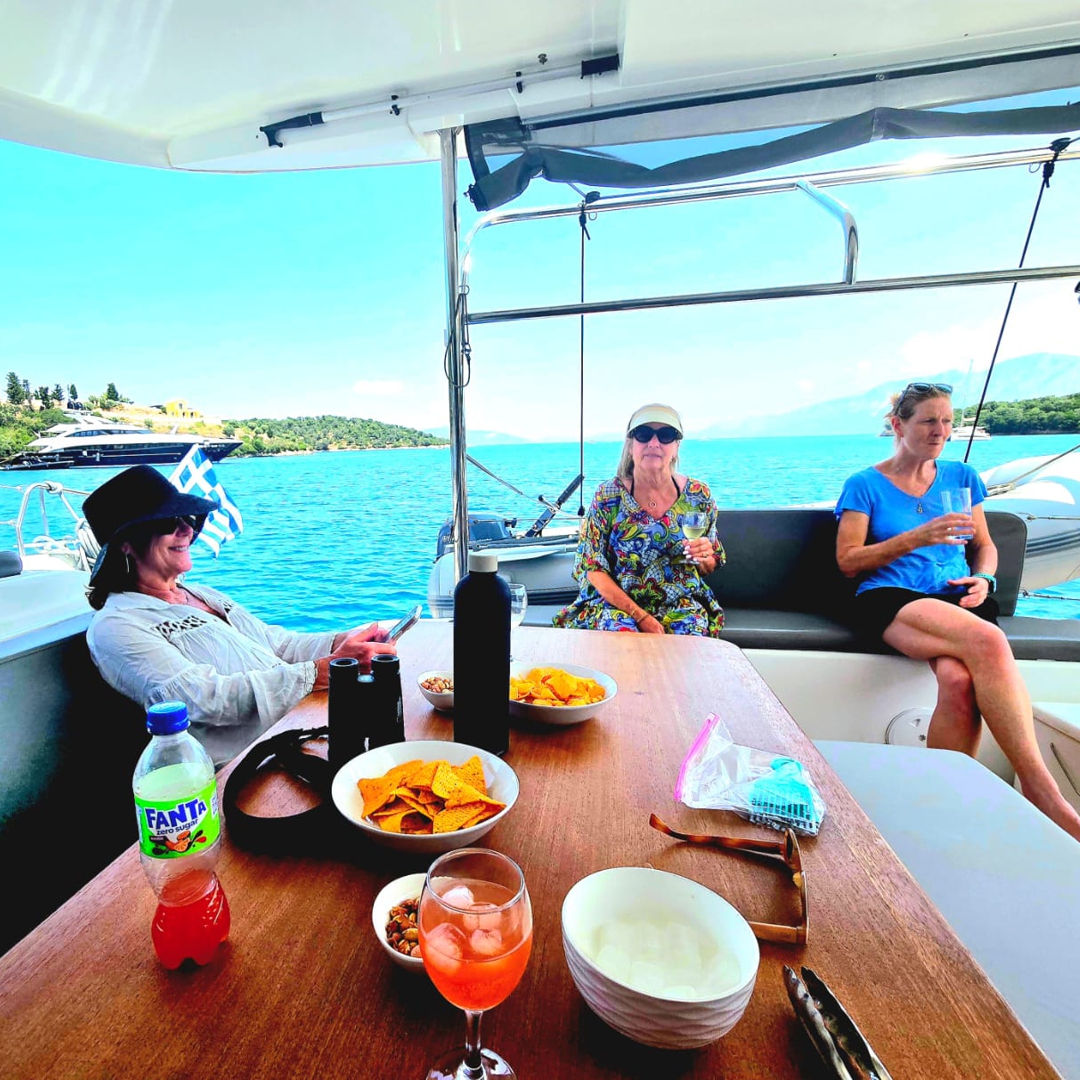 Guests relaxing on Catamaran JOY near Meganisi.